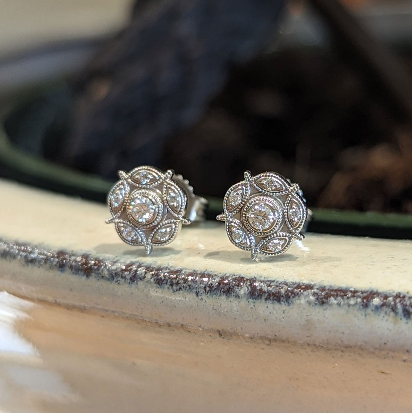 Photo of Diamond Flower Studs in a decorative scene, designed by , available at Plumb Gold & Plumb Silver