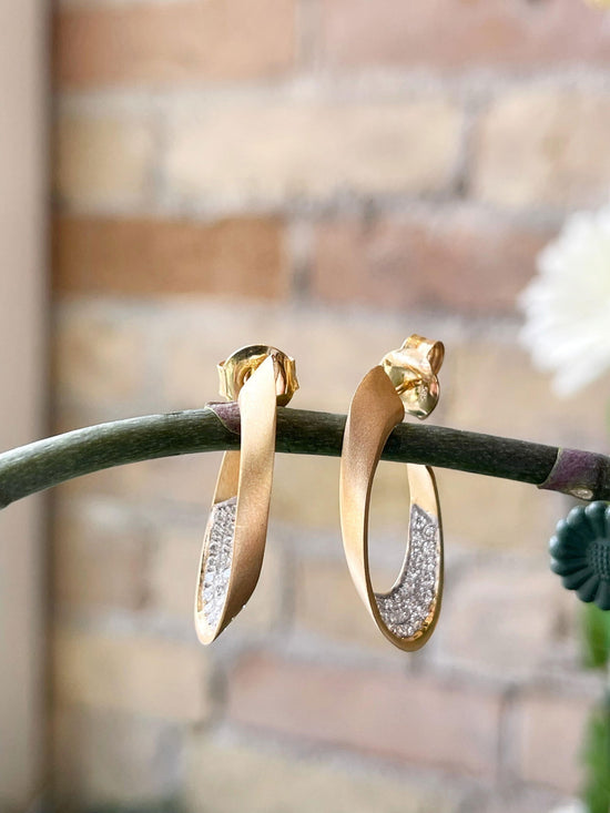 Photo of Diamond Gallery Earring in a decorative scene, designed by , available at Plumb Gold & Plumb Silver
