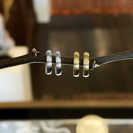 Photo of Diamond Mini Huggies in a decorative scene, designed by , available at Plumb Gold & Plumb Silver