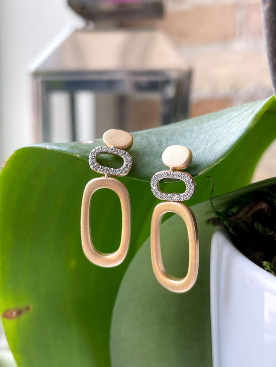 Photo of Diamond Oval Earrings in a decorative scene, designed by , available at Plumb Gold & Plumb Silver