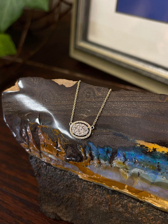 Photo of Diamond Oval Necklace in a decorative scene, designed by , available at Plumb Gold & Plumb Silver