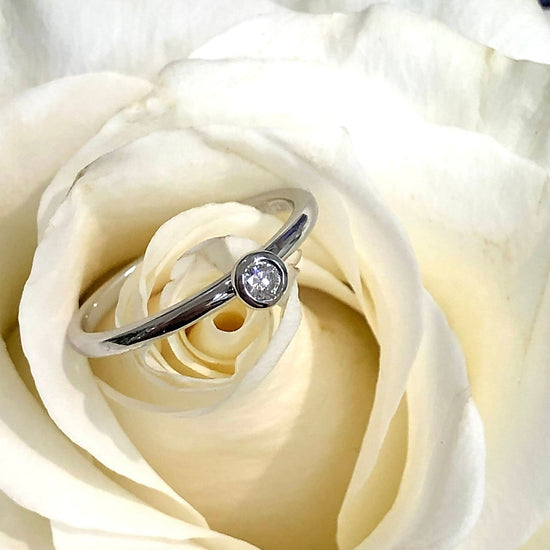 Photo of Diamond Stackable Ring in a decorative scene, designed by , available at Plumb Gold & Plumb Silver