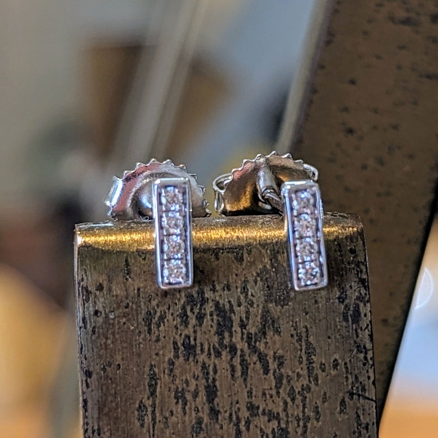 Photo of Diamond Stick Studs in a decorative scene, designed by , available at Plumb Gold & Plumb Silver