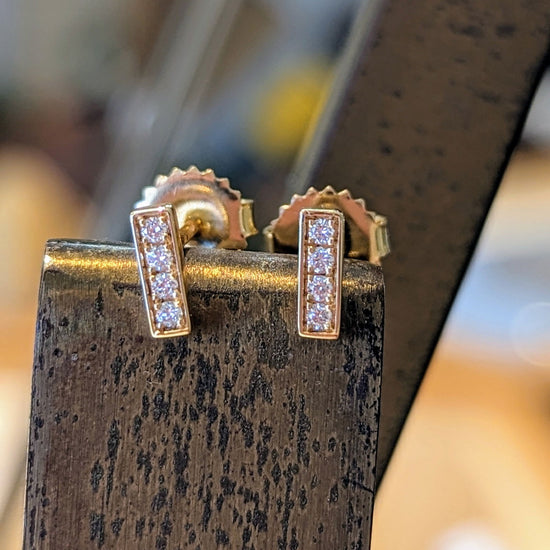 Photo of Diamond Stick Studs in a decorative scene, designed by , available at Plumb Gold & Plumb Silver