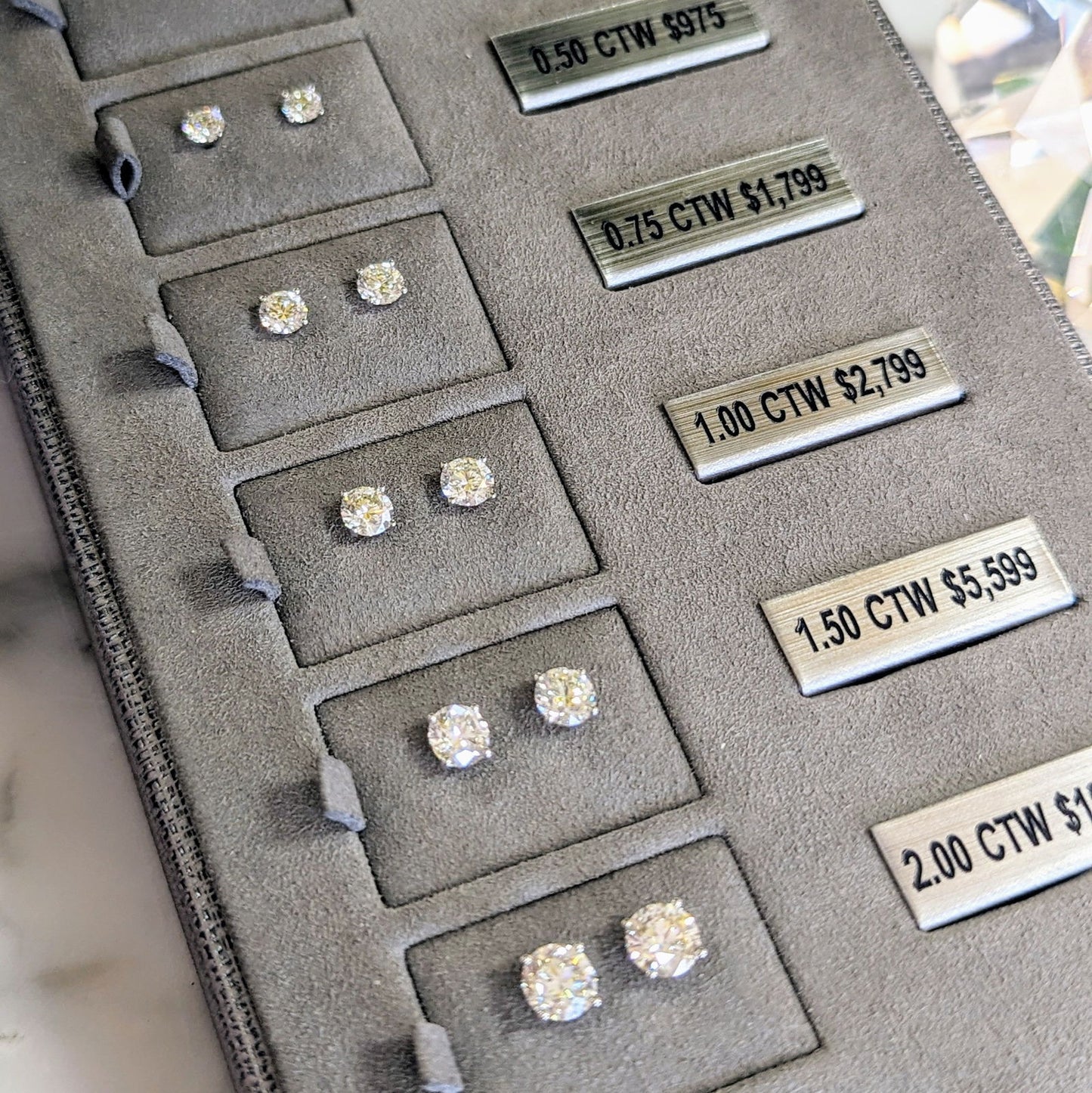 Photo of Diamond Studs in a decorative scene, designed by , available at Plumb Gold & Plumb Silver
