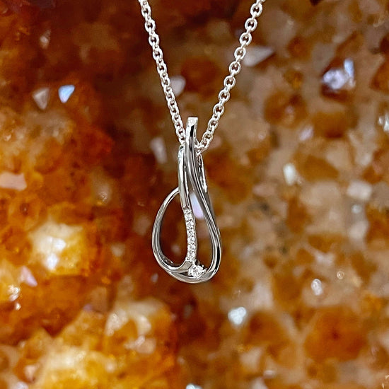 Photo of Diamond Teardrop Pendant in a decorative scene, designed by , available at Plumb Gold & Plumb Silver