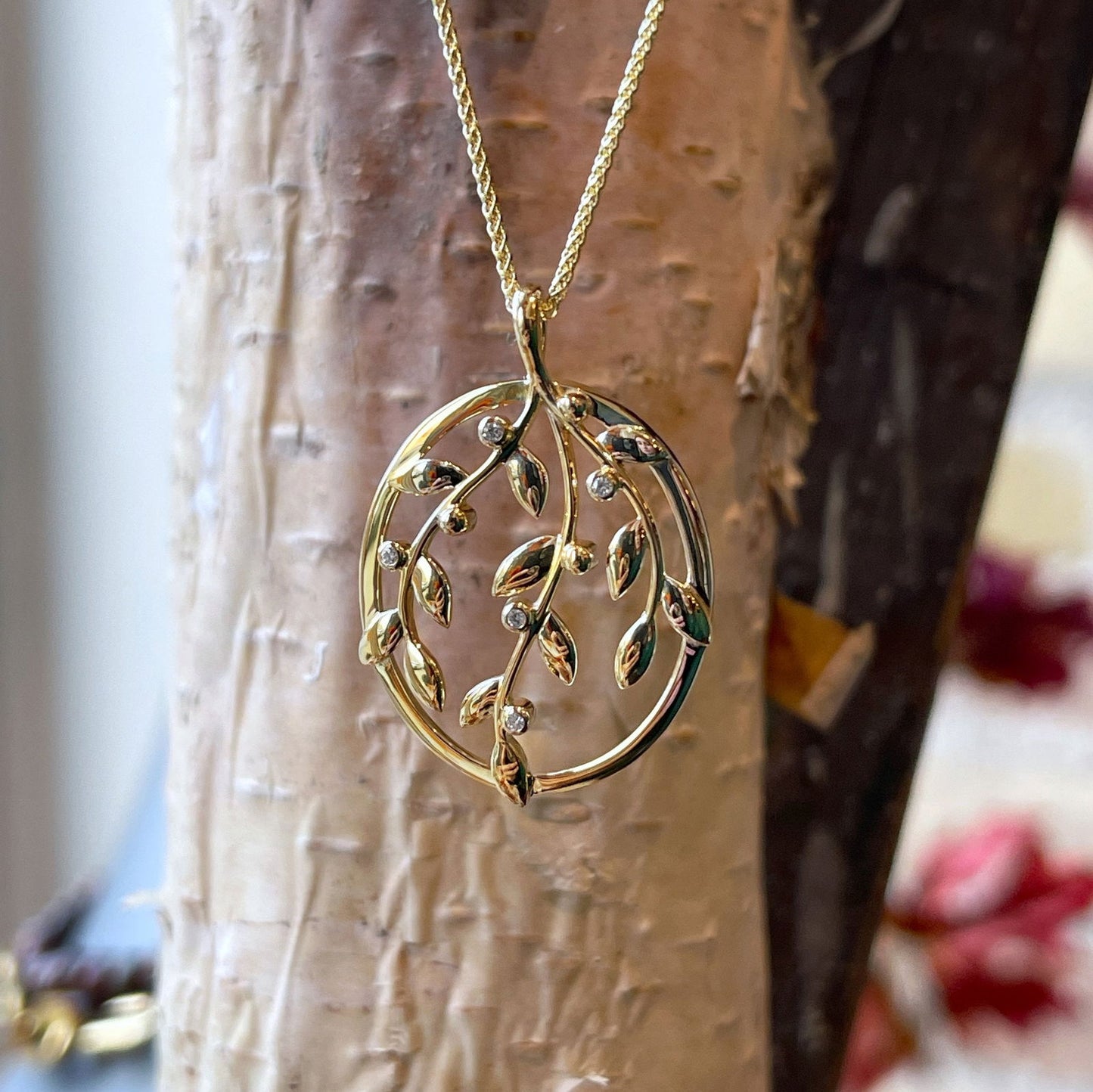 Photo of Diamond Vine Pendant in a decorative scene, designed by , available at Plumb Gold & Plumb Silver