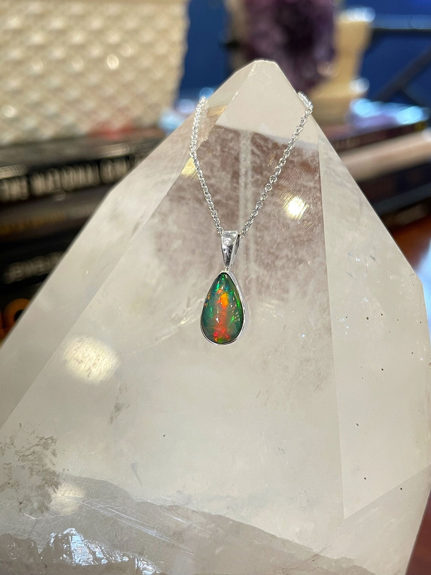 Photo of Dowdy Opal Teardrop Pendant in a decorative scene, designed by , available at Plumb Gold & Plumb Silver