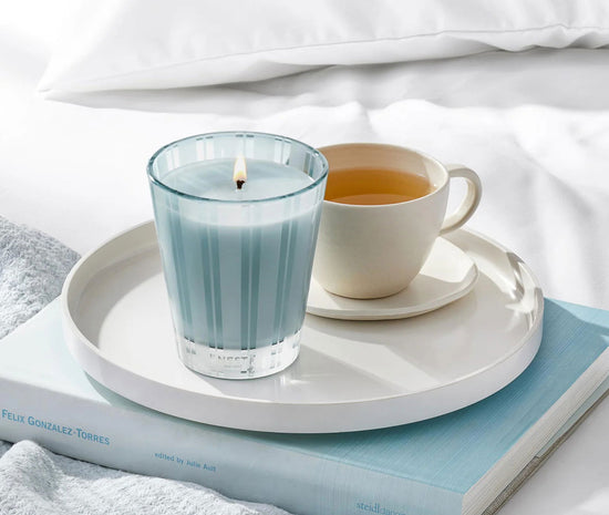 Photo of Driftwood and Chamomile Candle in a decorative scene, designed by , available at Plumb Gold & Plumb Silver