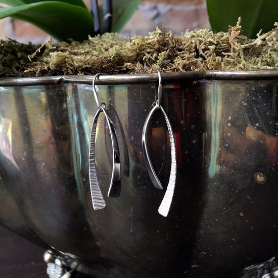 Photo of "Duet" Earrings in a decorative scene, designed by , available at Plumb Gold & Plumb Silver