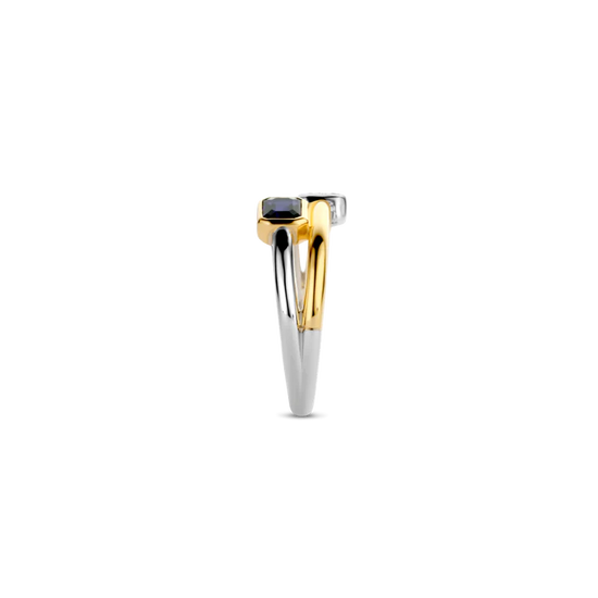 Photo of "Duo" Blue Bezel CZ Cluster Ring in a decorative scene, designed by , available at Plumb Gold & Plumb Silver