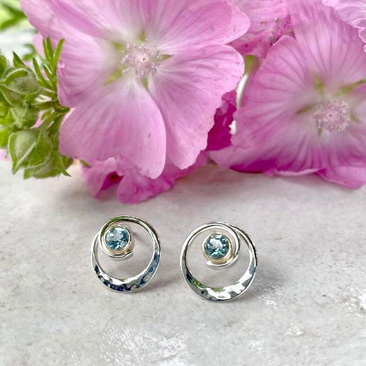 Photo of EL Designs "Posy" Blue Topaz Earrings in a decorative scene, designed by , available at Plumb Gold & Plumb Silver