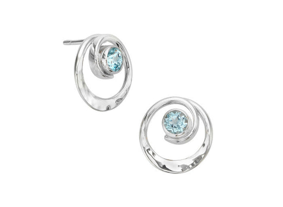 Photo of EL Designs "Posy" Blue Topaz Earrings in a decorative scene, designed by , available at Plumb Gold & Plumb Silver