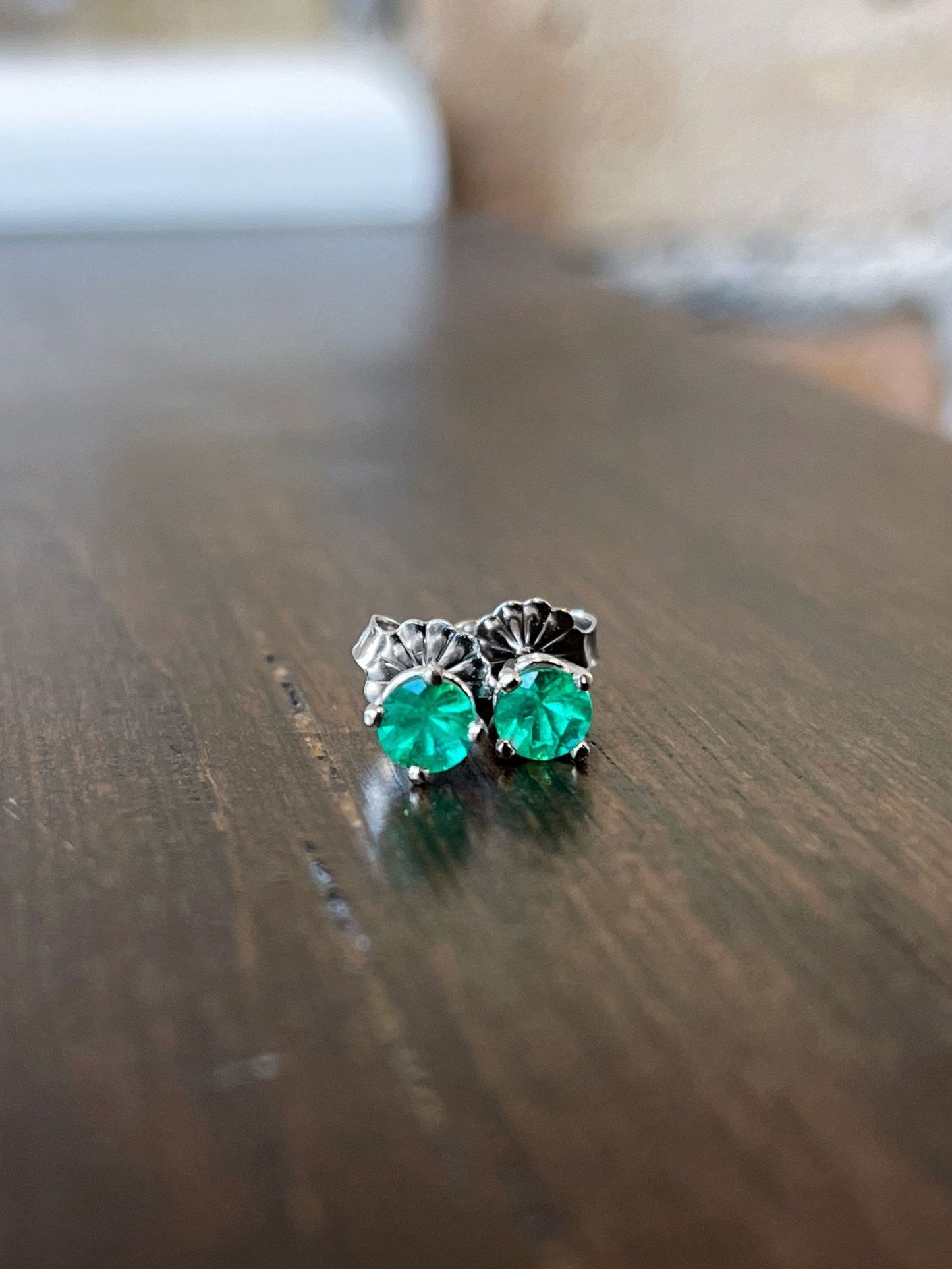 Photo of Emerald Studs in a decorative scene, designed by , available at Plumb Gold & Plumb Silver