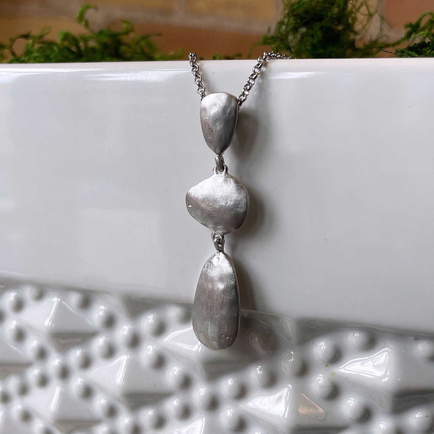 Photo of “Essential” Pendant in a decorative scene, designed by , available at Plumb Gold & Plumb Silver