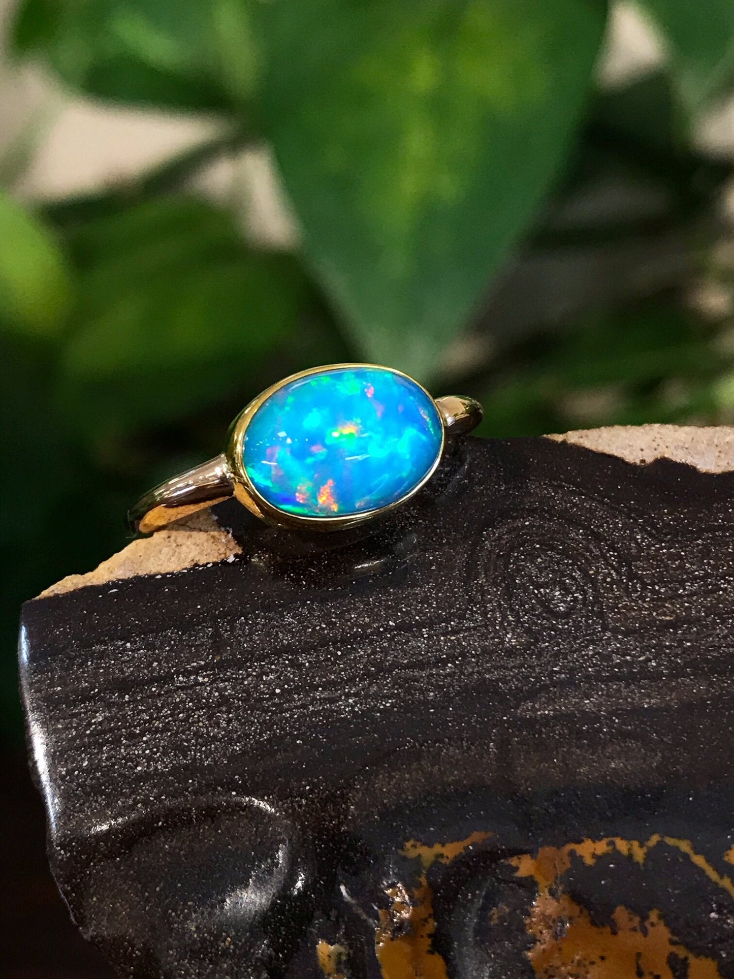 Photo of Ethiopian Opal Ring in a decorative scene, designed by , available at Plumb Gold & Plumb Silver