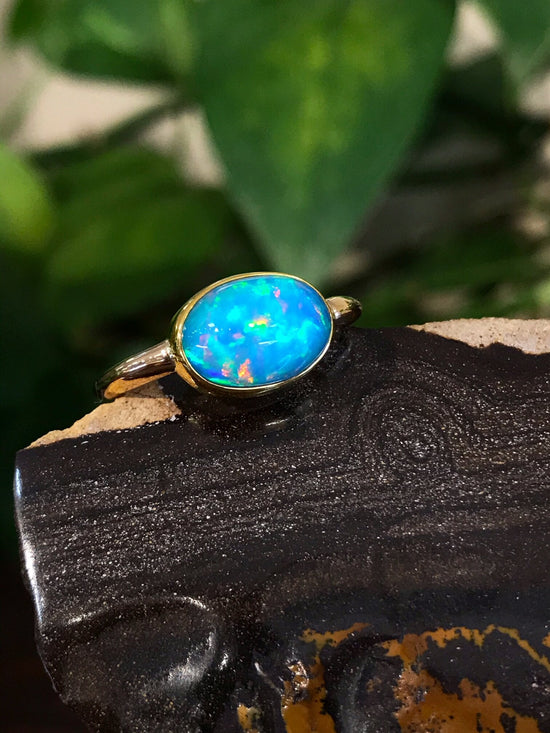 Photo of Ethiopian Opal Ring in a decorative scene, designed by , available at Plumb Gold & Plumb Silver