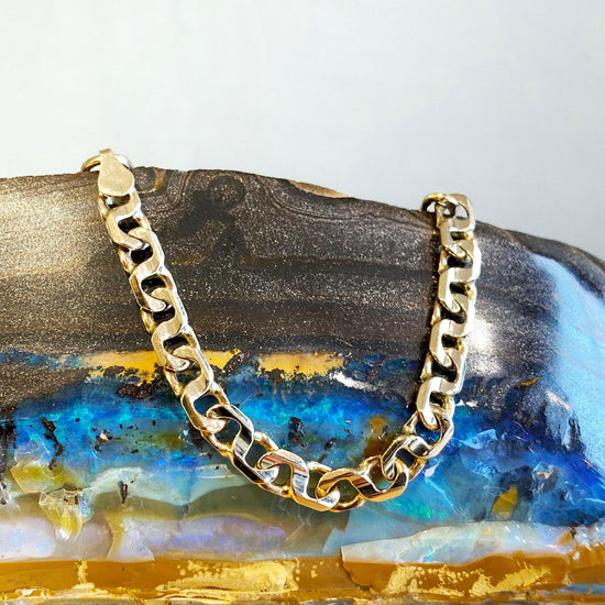 Photo of Fancy Link Bracelet in a decorative scene, designed by , available at Plumb Gold & Plumb Silver