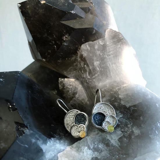 Photo of Five Circle Earrings in a decorative scene, designed by , available at Plumb Gold & Plumb Silver