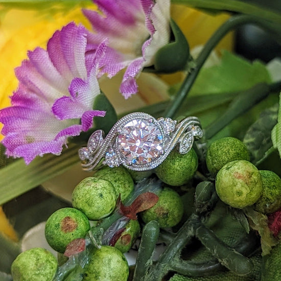 Photo of "Flora" Botanical Swirl Engagement Ring in a decorative scene, designed by , available at Plumb Gold & Plumb Silver