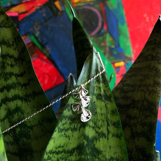 Photo of "Florida" Pendant in a decorative scene, designed by , available at Plumb Gold & Plumb Silver