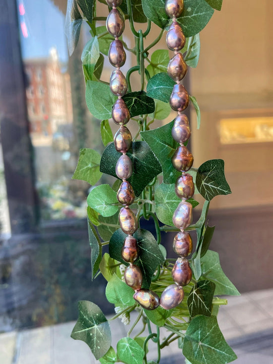 Photo of Freshwater Lavender Pearl Strand in a decorative scene, designed by , available at Plumb Gold & Plumb Silver
