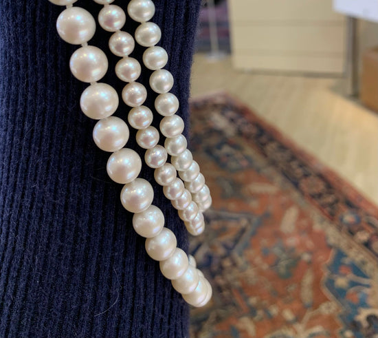 Photo of Freshwater Pearl Necklace in a decorative scene, designed by , available at Plumb Gold & Plumb Silver