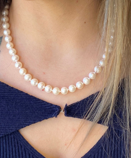 Photo of Freshwater Pearl Necklace in a decorative scene, designed by , available at Plumb Gold & Plumb Silver
