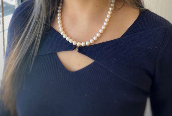 Photo of Freshwater Pearl Necklace in a decorative scene, designed by , available at Plumb Gold & Plumb Silver