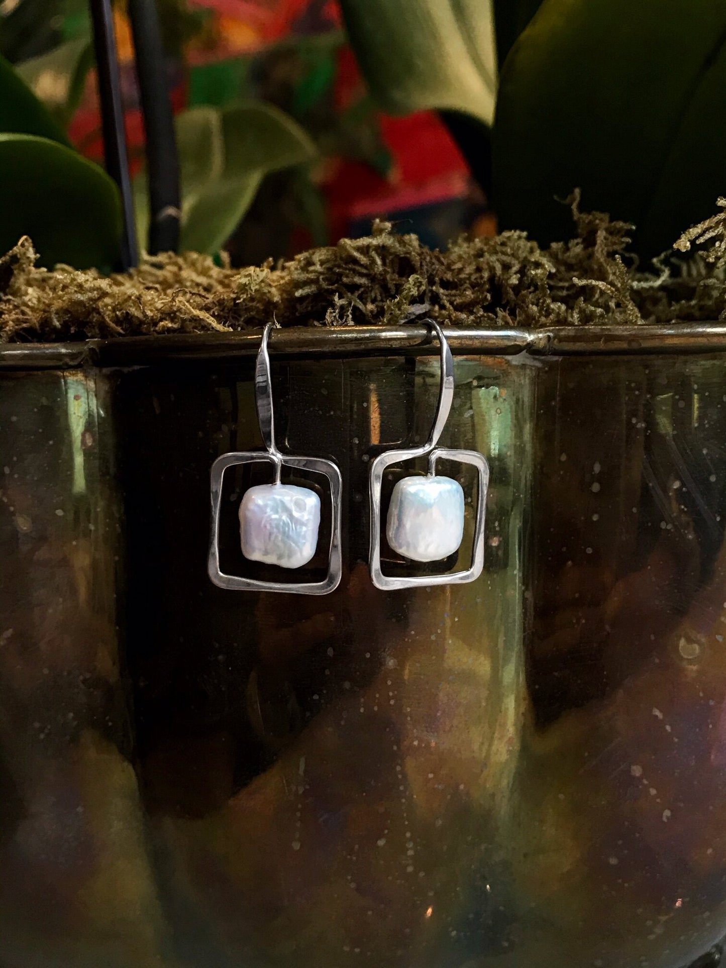 Photo of Freshwater Pearl "Zenith" Earrings in a decorative scene, designed by , available at Plumb Gold & Plumb Silver