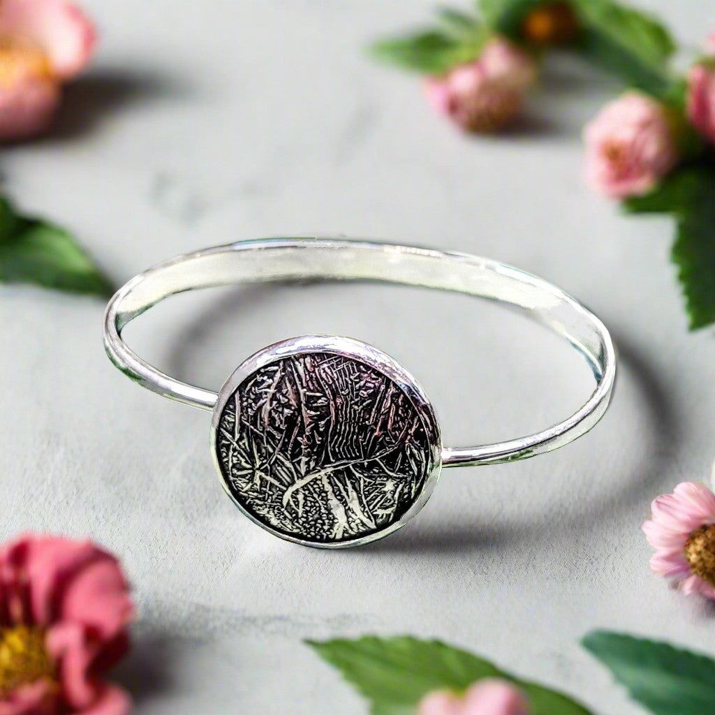 Photo of "Full Moon" Swing Bracelet in a decorative scene, designed by , available at Plumb Gold & Plumb Silver