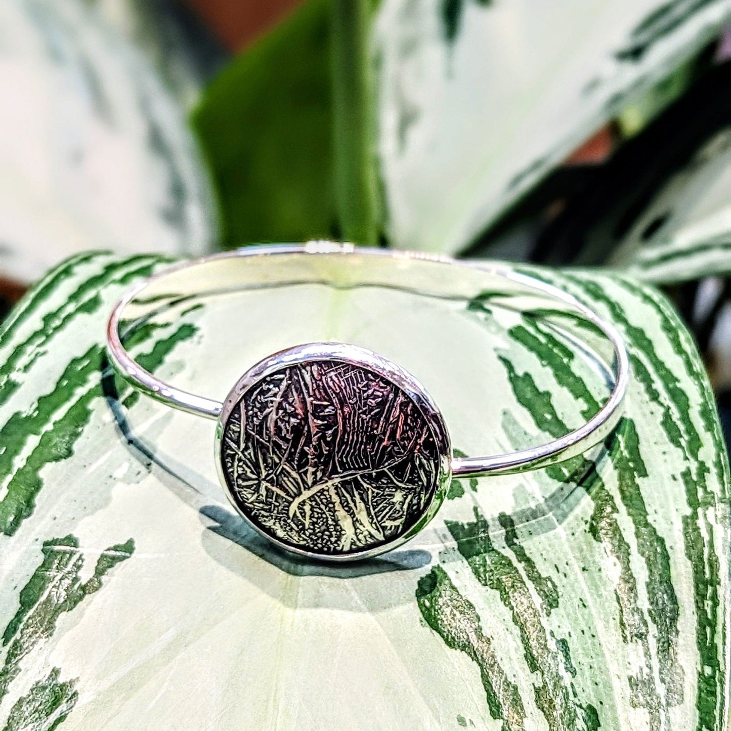 Photo of "Full Moon" Swing Bracelet in a decorative scene, designed by , available at Plumb Gold & Plumb Silver