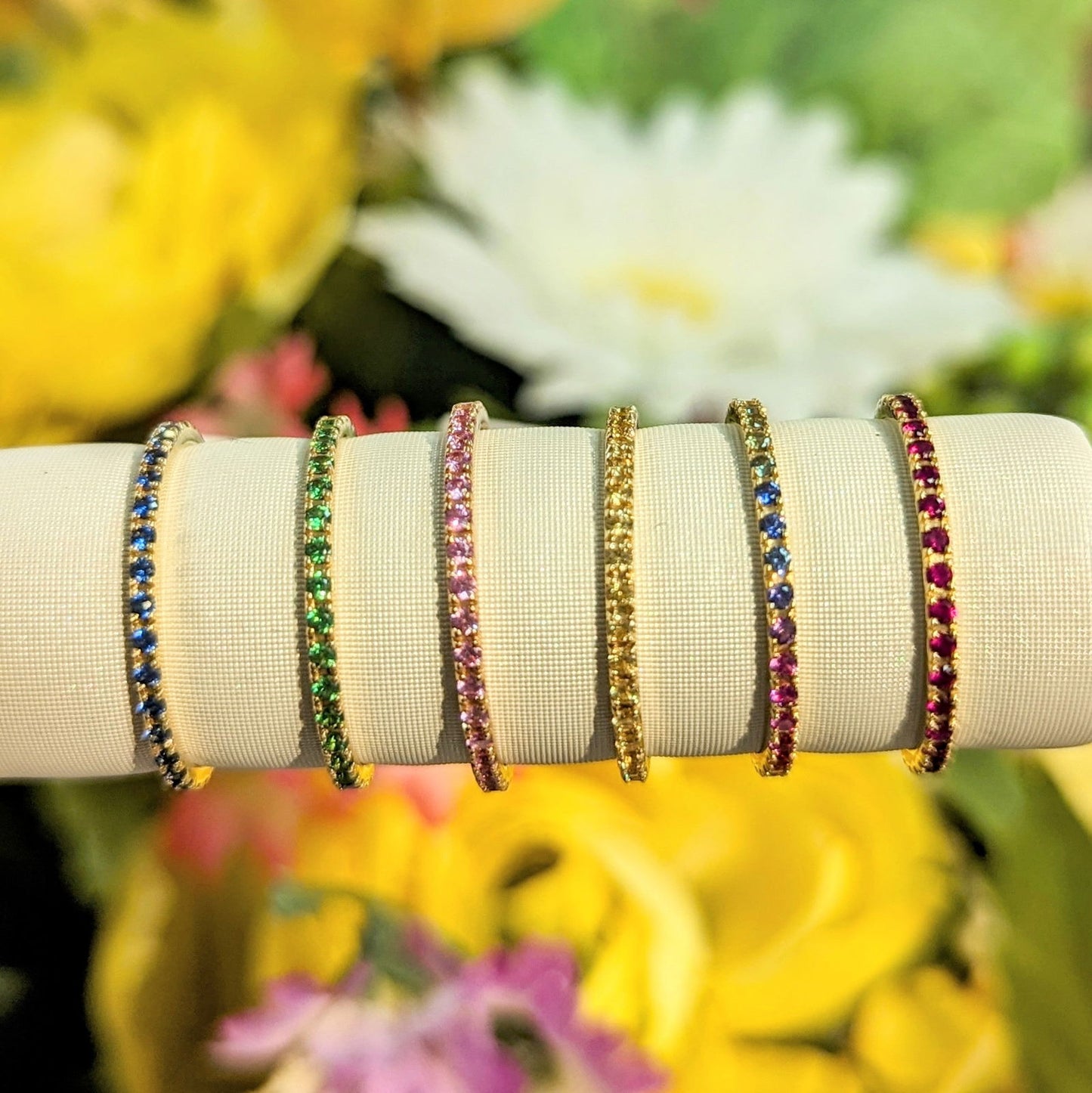 Photo of Gemstone Eternity Band in a decorative scene, designed by , available at Plumb Gold & Plumb Silver