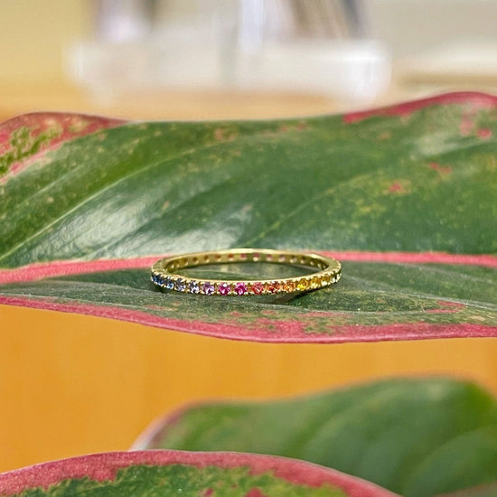 Photo of Gemstone Eternity Band in a decorative scene, designed by , available at Plumb Gold & Plumb Silver