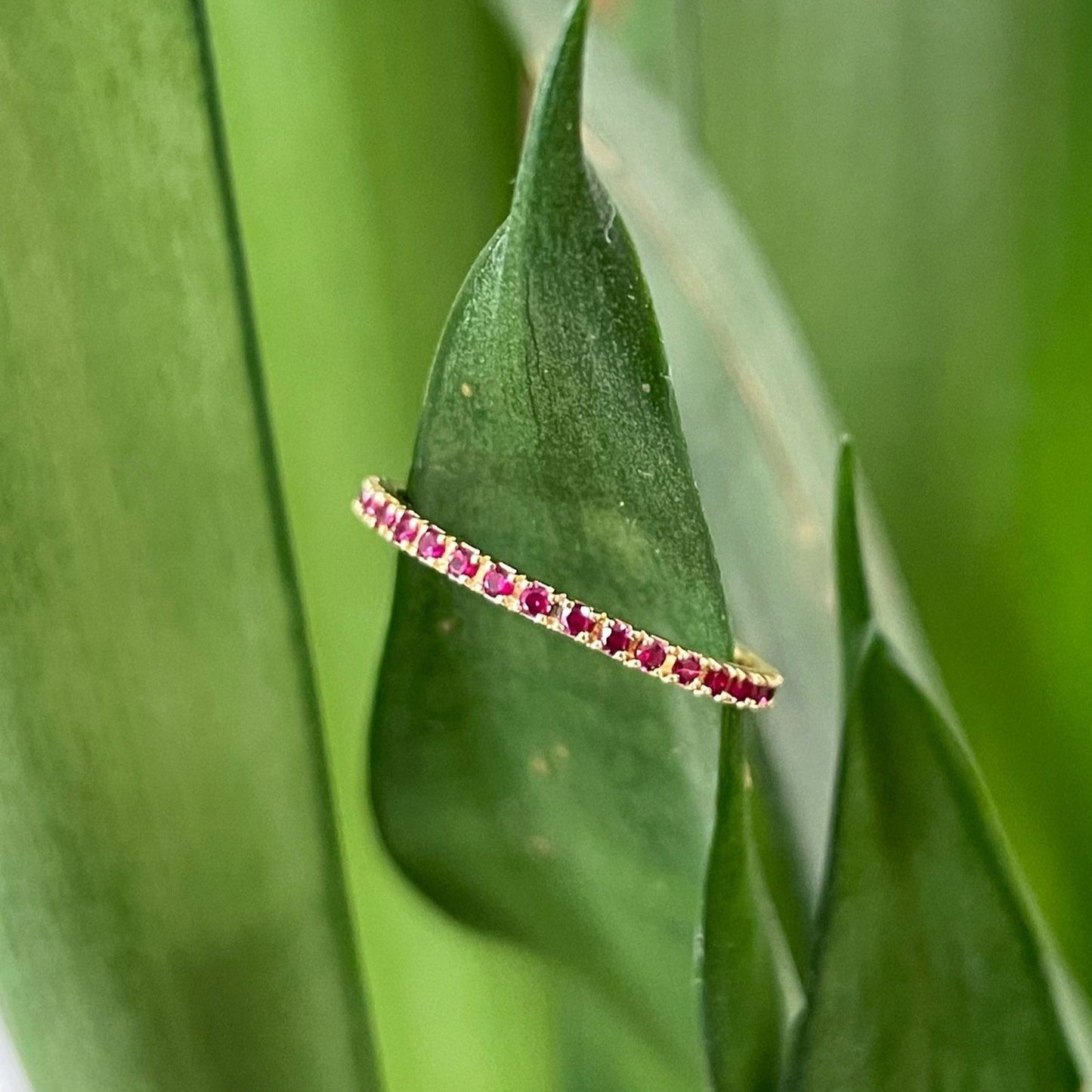 Photo of Gemstone Eternity Band in a decorative scene, designed by , available at Plumb Gold & Plumb Silver
