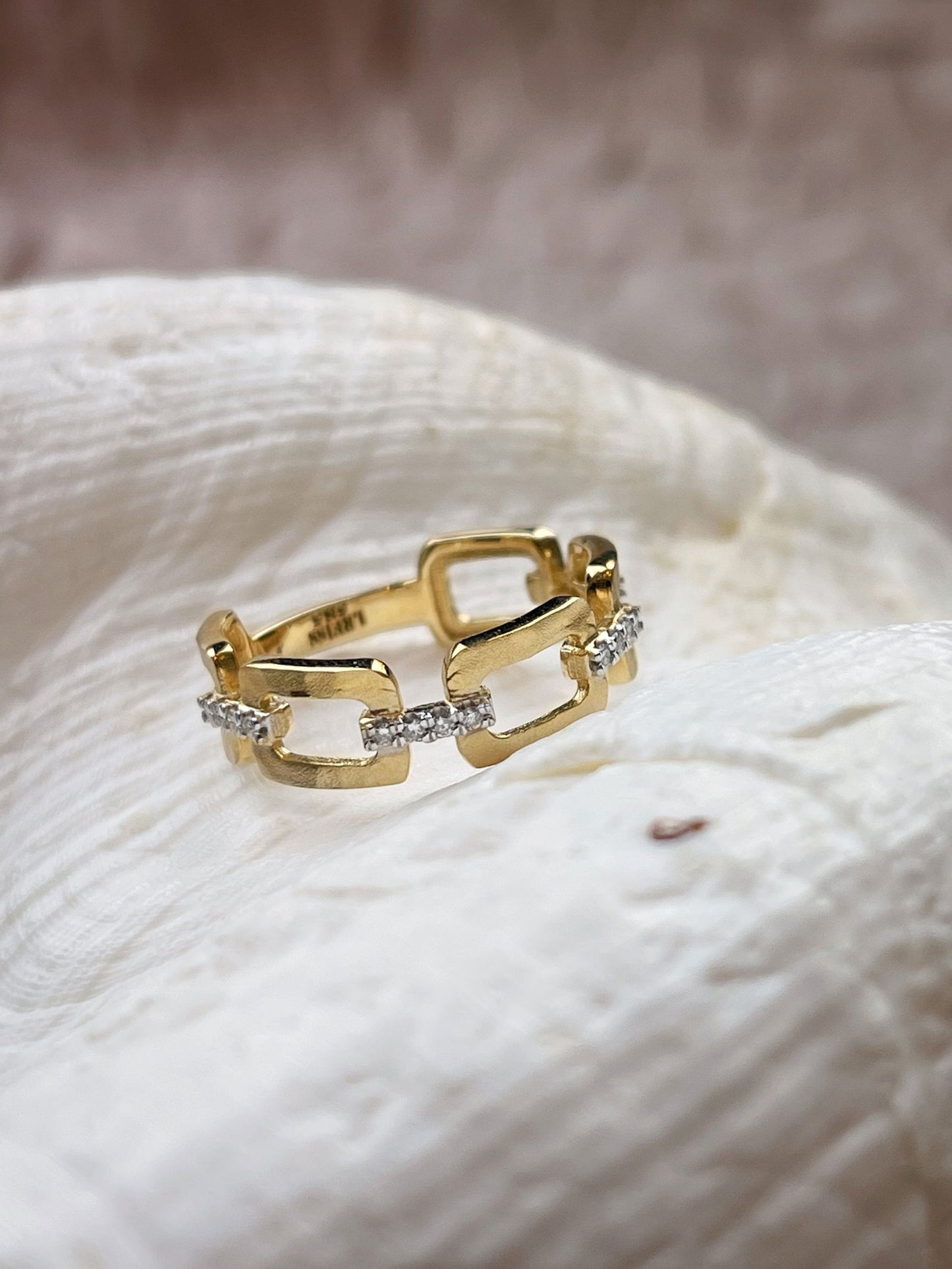 Photo of Geometric Diamond Ring in a decorative scene, designed by , available at Plumb Gold & Plumb Silver