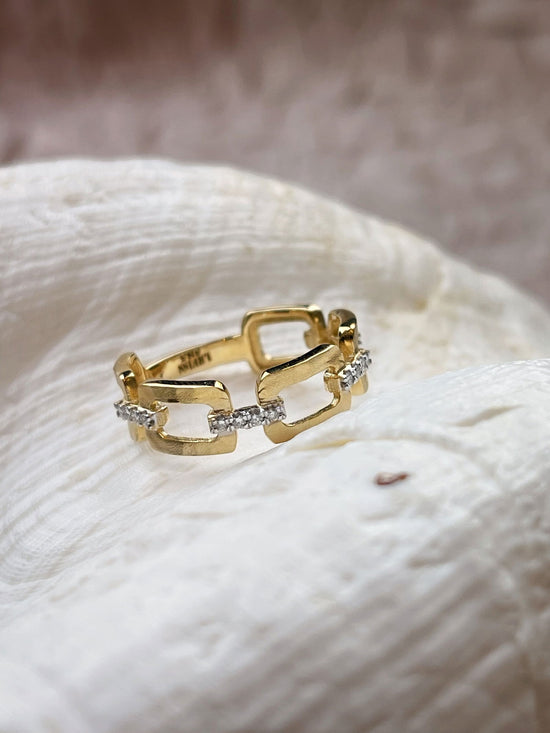 Photo of Geometric Diamond Ring in a decorative scene, designed by , available at Plumb Gold & Plumb Silver