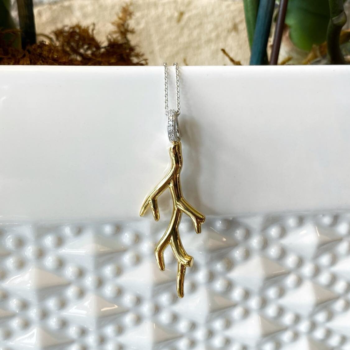 Photo of Gilded Coral Necklace in a decorative scene, designed by , available at Plumb Gold & Plumb Silver