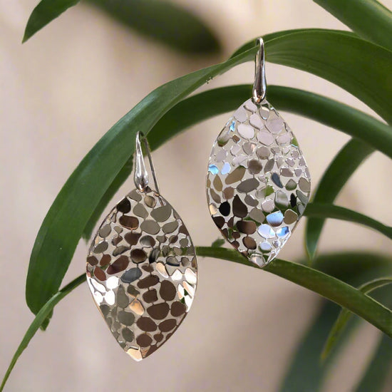 Photo of Gold Plated Mosaic Leaf Dangle Earrings in a decorative scene, designed by , available at Plumb Gold & Plumb Silver