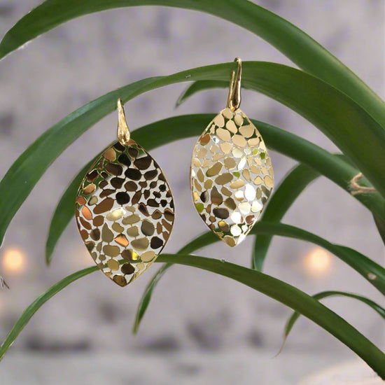 Photo of Gold Plated Mosaic Leaf Dangle Earrings in a decorative scene, designed by , available at Plumb Gold & Plumb Silver