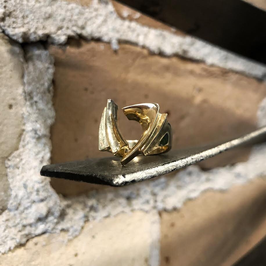 Photo of H.L Designs Modern Triangle Ring in a decorative scene, designed by , available at Plumb Gold & Plumb Silver