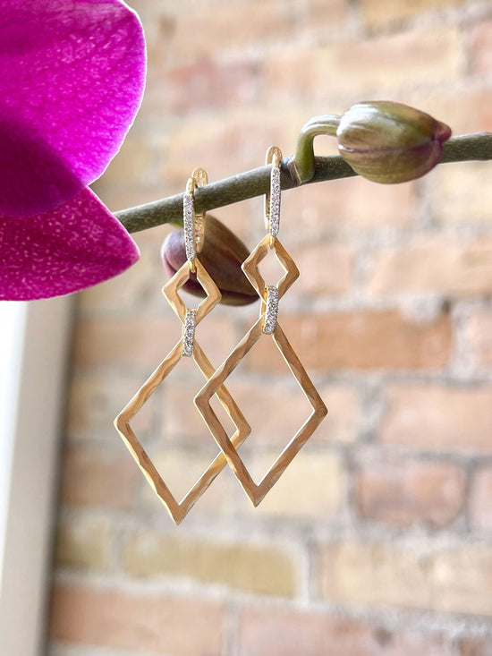 Photo of Hammered Geometric Dangle in a decorative scene, designed by , available at Plumb Gold & Plumb Silver