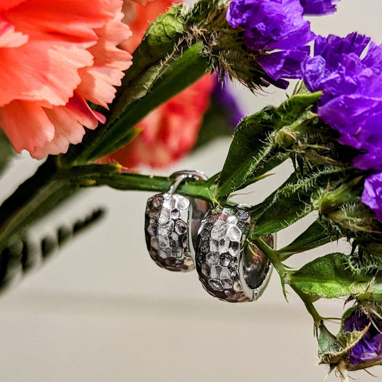 Photo of Hammered Hinged Hoop Earring in a decorative scene, designed by , available at Plumb Gold & Plumb Silver