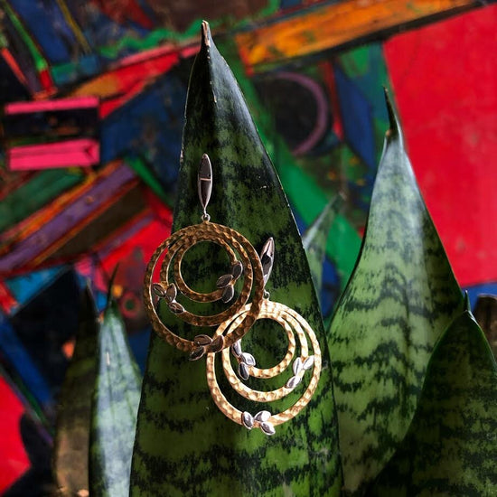 Photo of "Hebe" Earring in a decorative scene, designed by , available at Plumb Gold & Plumb Silver
