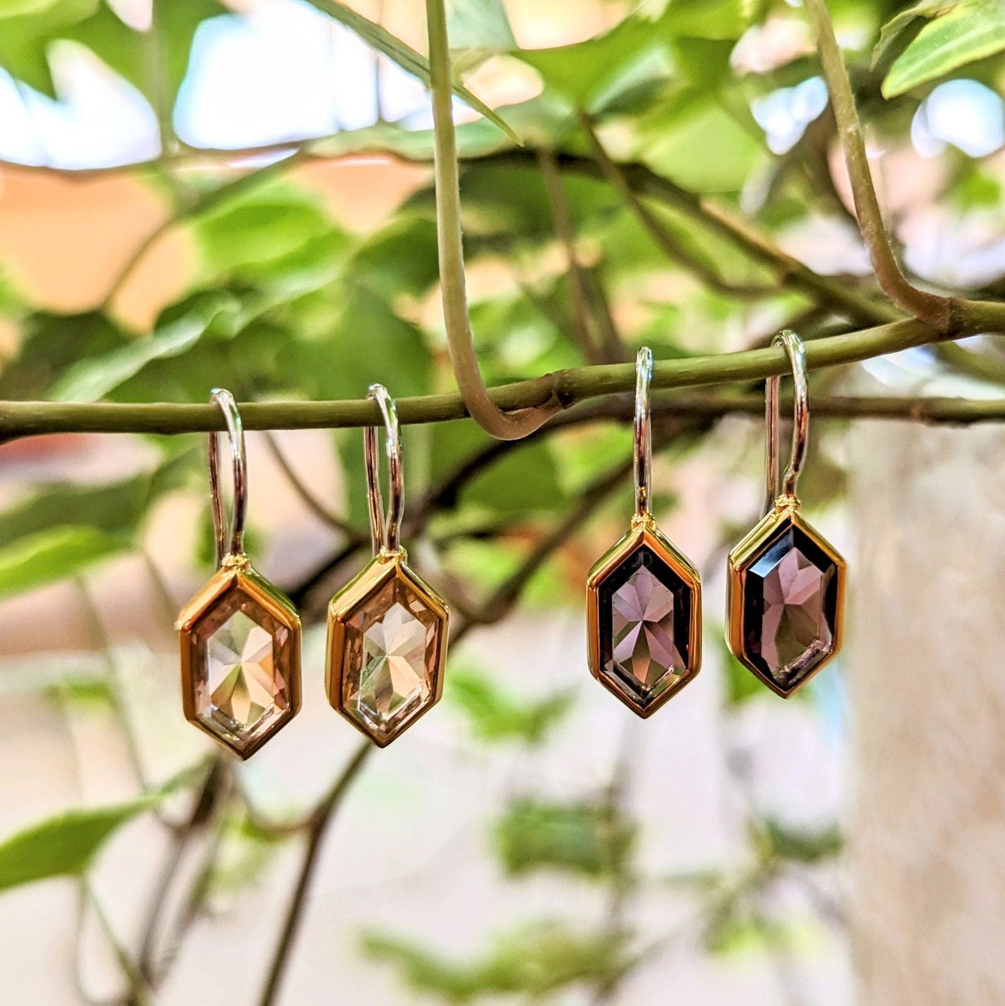 Photo of Hex Drop Earrings in a decorative scene, designed by , available at Plumb Gold & Plumb Silver