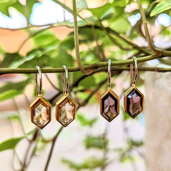 Photo of Hex Drop Earrings in a decorative scene, designed by , available at Plumb Gold & Plumb Silver