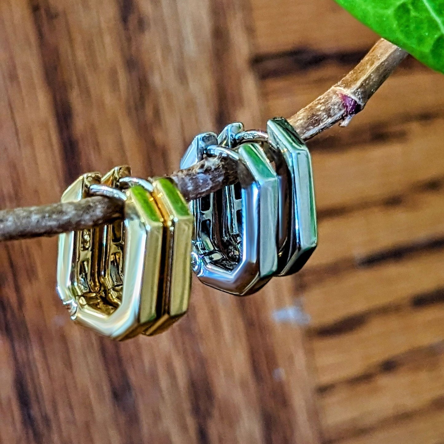 Photo of Hex Hinged Hoops in a decorative scene, designed by , available at Plumb Gold & Plumb Silver