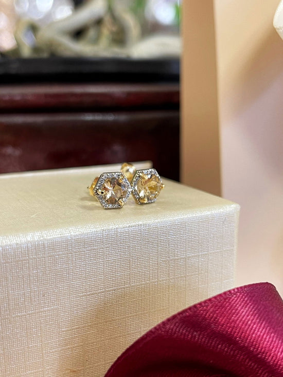 Photo of Imperial Topaz Hexagon Studs in a decorative scene, designed by , available at Plumb Gold & Plumb Silver
