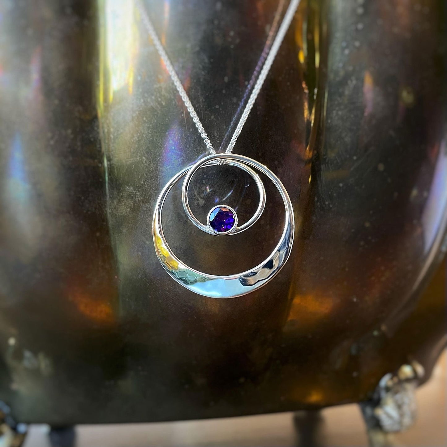 Photo of "Juliet" Amethyst Necklace in a decorative scene, designed by , available at Plumb Gold & Plumb Silver