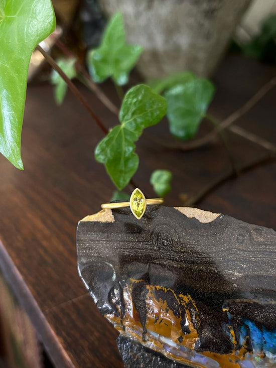 Photo of Kim Collins Canary Tourmaline Ring in a decorative scene, designed by , available at Plumb Gold & Plumb Silver